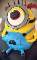  ??  ?? Eye-cing on the cake: A Minion adorns the top of one creation