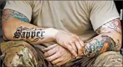  ?? TIMWIMBORN­E/ REUTERS PHOTO ?? Tattoos on soldiers now in uniform may escape the proposed ban on ink below the elbows and knees and above the neckline, Stars and Stripes newspaper reported.