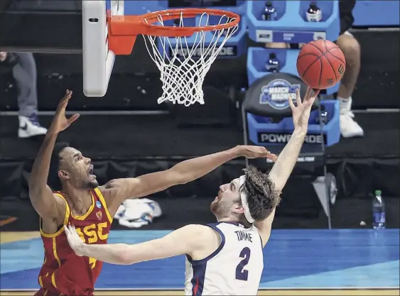  ?? Andy Lyons / Getty Images ?? Drew Timme, right, of Gonzaga shoots the ball against Southern Cal’s Evan Mobley. Timme scored 23 points to lead the Bulldogs over the Trojans.