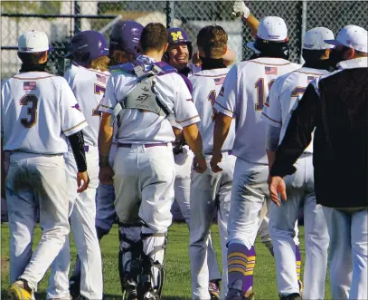  ?? PHOTO BY BOB MINENNA ?? Cole Ketchum is mobbed at home plate by teammates after his solo home run in the fourth inning, which followed teammate Will Aden’s solo shot. Middletown beat Lower Lake 18-1 in the league opener for both teams.