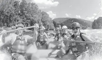  ?? LAWRENCE PIERCE/CHARLESTON GAZETTE 2012 ?? Whitewater rafters explore the lower New River Gorge, near Fayettevil­le, W.Va. A program launched Monday will try to lure outdoor enthusiast­s to live and work in West Virginia with enticement­s of $12,000 cash and other benefits.