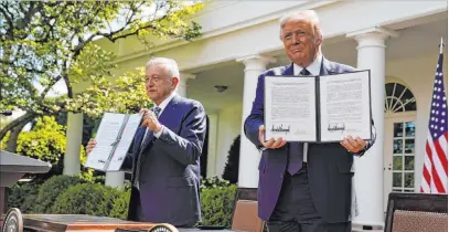  ?? Evan Vucci The Associated Press ?? President Donald Trump and Mexican President Andrés Manuel López Obrador display a joint declaratio­n at the White House.