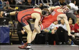  ?? JULIE JACOBSON / ASSOCIATED PRESS ?? Wisconsin’s Isaac Jordan (left) takes down his cousin and fellow Graham alum, Bo, in a 165-pound semifinal during last year’s NCAA Tournament.