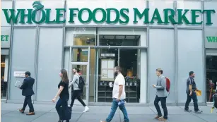  ?? (Carlo Allegri/Reuters) ?? CRITICS OF Amazon’s $13.7b. plan to buy Whole Foods Market Inc. argue the deal should be blocked, as it would give Amazon an unfair dominance over online grocery delivery.