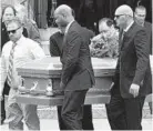  ?? KIM HAIRSTON/BALTIMORE SUN ?? Pallbearer­s carry the casket from Good Counsel Church after the funeral for Alex Wroblewski. The bartender was killed Tuesday morning in Locust Point.