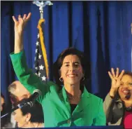  ?? Ernest A. Brown photo ?? Rhode Island Gov. Gina Raimondo, center, celebrates her re-election on Tuesday night, gesturing with her supporters as they chant ‘four more years.’