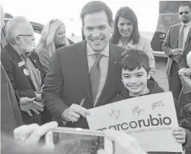  ?? John Byrum / The Spartanbur­g Herald-Journal via Associated Press ?? GOP presidenti­al candidate Marco Rubio has at least two fans in South Carolina. In Spartanbur­g, Rubio shares a laugh with Kyle Williams, 10, who is too young to vote. Gov. Nikki Haley endorsed the junior senator from Florida on Thursday.