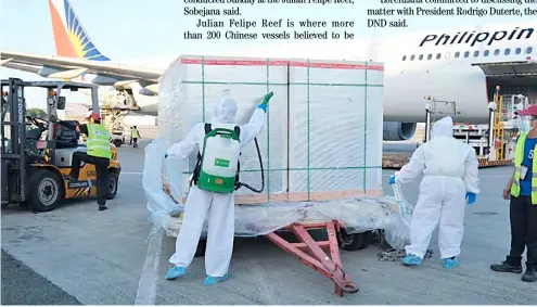  ??  ?? Bought not donated A crate containing half a million doses of Sinovac vaccines from China is disinfecte­d after unloading from a Philippine Airlines plane.