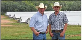  ?? PHOTOS BY STACI VANDAGRIFF/THREE RIVERS EDITION ?? James Davis, left, and his son, Austin Davis, pose in front of the family’s poultry houses.