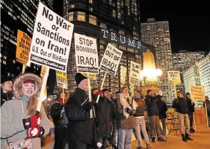  ?? CHARLES REX ARBOGAST THE ASSOCIATED PRESS ?? Protesters of President Donald Trump’s recent military action in Iraq gather across the Chicago River from the Trump Tower earlier this week in Chicago. Iraqis have feared for months that their land would turn into a battlegrou­nd in a conflict between the U.S. and Iran.