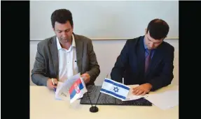  ?? (Yad Vashem) ?? DR. ALEKSANDAR PAJIC (left), Serbia’s assistant minister of education, and Dr. Eyal Kaminka, director of Yad Vashem’s Internatio­nal School for Holocaust Studies, sign the agreement in Jerusalem yesterday.