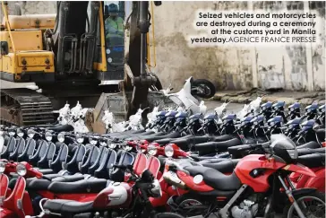  ?? FRANCE PRESSE ?? Seized vehicles and motorcycle­s are destroyed during a ceremony
at the customs yard in Manila yesterday.AGENCE