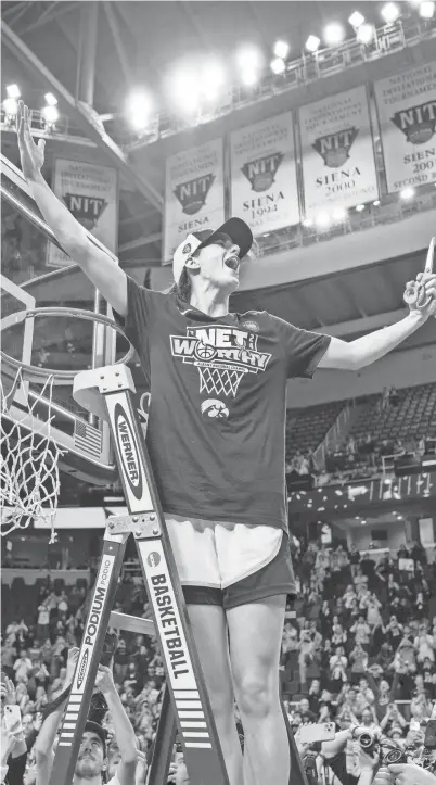  ?? ZACH BOYDEN-HOLMES/DES MOINES REGISTER ?? Caitlin Clark cuts down the net for the last time after a 41-point outing to help beat LSU, 94-87, in the Elite Eight of this year’s NCAA Tournament in Albany, N.Y.