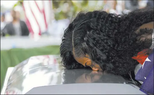  ?? Matias J. Ocner The Associated Press ?? Myeshia Johnson kisses the casket of her husband, Sgt. La David Johnson, during his burial Saturday at Hollywood Memorial Gardens in Hollywood, Fla. Johnson was among four soldiers killed Oct. 4 in Niger.