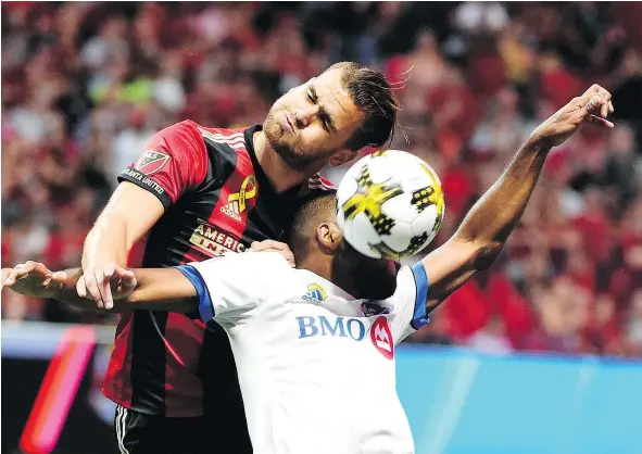  ?? — USA TODAY ?? Atlanta United defender Leandro Gonzalez, left, smothers an attempt to head the ball by Montreal Impact forward Anthony Jackson-Hamel during the first half at Mercedes-Benz Stadium. The Impact’s playoffs hopes suffered a severe blow with Sunday’s 2-0...