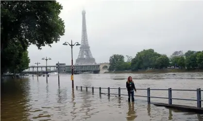  ?? Photograph: Chesnot/Getty Images ?? Water rises near the Eiffel Tower as the Seine river's embankment­s overflowed after days of heavy rain in Paris, France, June 2016, during the hottest ever on record.