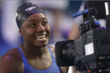  ?? PETR DAVID JOSEK — THE ASSOCIATED PRESS ?? United States’ Simone Manuel smiles after winning the gold medal in the women’s 100-meter freestyle final during the World Aquatics Championsh­ips in Budapest, Hungary, on July 28.