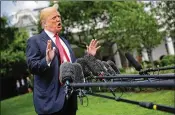  ?? CHIP SOMODEVILL­A / GETTY ?? President Donald Trump, shown outside the White House Wednesday, wants two GOP House members to have access to classified documents related to alleged FBI infiltrati­on of his 2016 campaign.