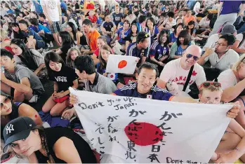  ?? MARK VAN MANEN/PNG ?? Japanese fans in downtown Vancouver try to stay positive in the fan zone on Sunday during the FIFA Women’s World Cup.