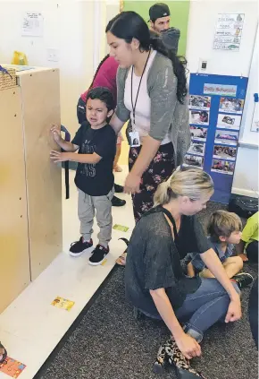  ?? ROBERT NOTT/THE NEW MEXICAN ?? Educationa­l assistant Julie Castañeda comforts Matthew Aparicio on Monday on the first day of pre-kindergart­en at Tesuque Elementary School. She said that ‘magic’ occurs after parents depart and most of the children adapt and settle down.