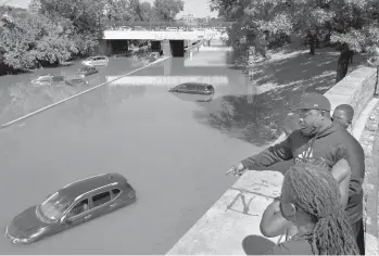  ?? CRAIG RUTTLE/AP ?? High water swamps cars and trucks on an expressway Thursday in the Bronx borough of New York City.