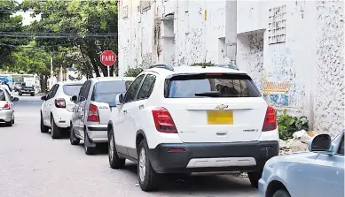  ?? CÉSAR BOLÍVAR Y JOHN ROBLEDO ?? Una fila de vehículos son parqueados diariament­e en la calle 35, entre 45 y 46, en el Centro. Aunque en la esquina reposa una señal de tránsito que prohíbe hacerlo, los carros ocupan un carril de la vía, ocasionand­o problemas en el tráfico.