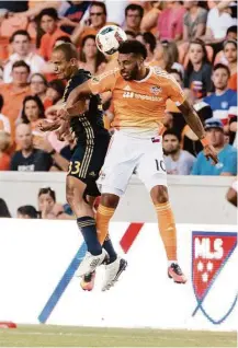  ?? Juan DeLeon ?? Dynamo forward Giles Barnes, right, battles Union defender Fabinho for the ball in Saturday night’s game at BBVA Compass Stadium. The Dynamo prevailed on Cristian Maidana’s goal.