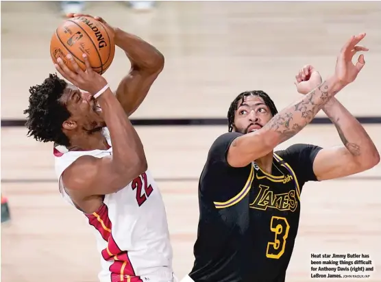  ?? JOHN RAOUX/AP ?? Heat star Jimmy Butler has been making things difficult for Anthony Davis (right) and LeBron James.