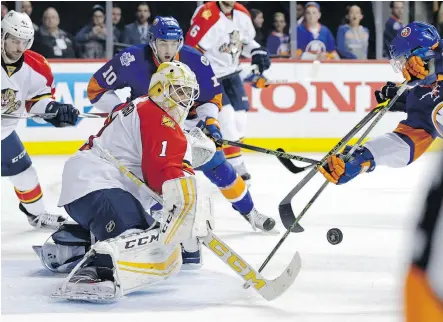  ?? ADAM HUNGER/THE ASSOCIATED PRESS ?? Roberto Luongo of the Florida Panthers makes a key save in Game 4, stopping 26 of 27 shots in the Panthers’ 2-1 win in Brooklyn on Wednesday to draw the Panthers even in the series against the Islanders.