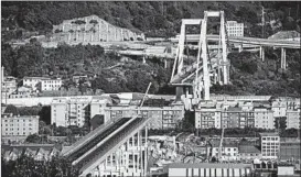  ?? JACK TAYLOR/GETTY ?? The Morandi Bridge partially stands after a large section of it collapsed earlier this week.