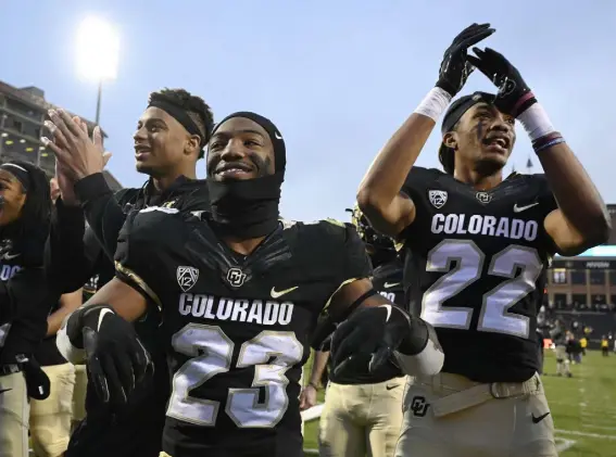  ?? Photos by Andy Cross, The Denver Post ?? Colorado Buffaloes wide receiver Brenden Rice, left, running back Jarek Broussard, center, and safety Toren Pittman celebrate after defeating the Washington Huskies 20-17.