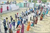  ??  ?? Voters standing in queue to vote during the Panchayat Polls in Prayagraj district on Thursday.