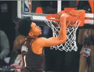  ?? AFP ?? Anfernee Simons of the Portland Trail Blazers dunks on his way to victory in Sunday’s AT&T Slam Dunk Contest at State Farm Arena.