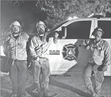  ?? Courtesy ?? Pictured above are Bob Harrold, on the right, and two members of his crew, Eric Jackson, left, and Devin Leiren in front of Harrold’s truck. The photo was taken while the crew was fighting fires in California last fall.