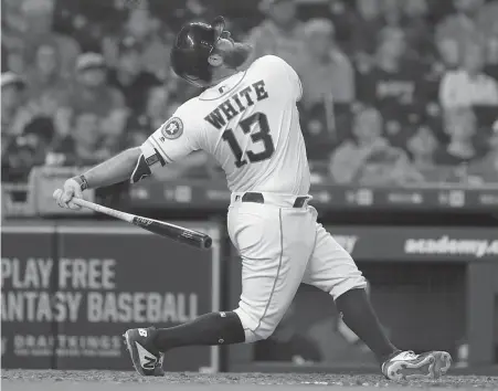  ?? Karen Warren / Staff photograph­er ?? After all his recent heroics, Tyler White takes a mighty swing in the ninth inning but pops up in the Astros’ 4-3 loss Tuesday night.