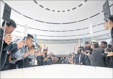  ?? KARL MONDON — STAFF PHOTOGRAPH­ER ?? Attendees at Apple’s product launch Wednesday photograph the tech giant’s new releases.