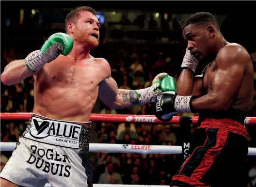  ?? Photo: AL BELLO/GETTY IMAGES ?? WHAT HE DOES BEST: Canelo attacks Jacobs en route to victory last year