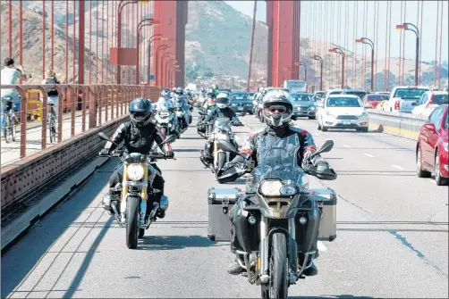  ?? ALISA CLICKENGER VIA AP ?? Alisa Clickenger leads a group of women riders over the Golden Gate Bridge in San Francisco in July 2016 at the end of a cross-country trip to honor two sisters from Brooklyn, N.Y., who made a similar ride in 1916.