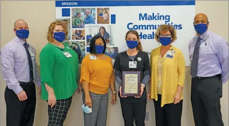  ?? Special to The Saline Courier ?? Recipient of the 2020 Inpatient Division Employee of the Year award Jessica Starkey, third from right, is honored by Saline Health Systems. She stands with, from right, Dave Santoemma, Lisa Sheppard, Tamika Tyus, Katie Lea and Michael Stewart.