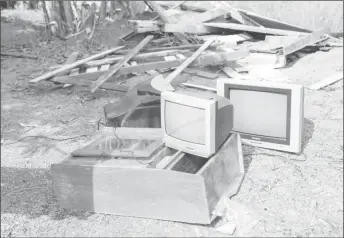  ?? (Photo by Keno George) ?? These television­s were among a number of items found in one of the shacks that was torn apart.