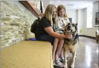  ?? LAUREN A. LITTLE — MEDIANEWS GROUP ?? Alecia Eberly and Saannah Pagerly wait with Jynx for an appointmen­t at Hope Veterinary Specialist­s. Jynx was recently diagnosed with cancer.