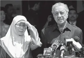  ??  ?? Prime Minister Mahathir Mohamad speaks next to Justice Party president Wan Azizah, wife of Anwar Ibrahim, at a press conference in Kuala Lumpur.(Photo: Reuters)