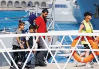  ?? Reuters ?? Migrants picked up from small boats arrive at the Haywharf maritime base in Valletta’s Marsamxett Harbour, Malta, on Sunday.