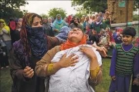  ?? Dar Yasin / Associated Press ?? A Kashmiri woman wails holding on to the school shirt of her brother Umar Abdullah Kumar during his funeral procession at Pinjura village in Indian-controlled Kashmir on Thursday. Umar was killed and dozens others wounded after Indian troops fired at...