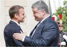  ?? — Reuters ?? French President Emmanuel Macron meets with Ukrainian President Petro Poroshenko at the Elysee Palace in Paris on Monday.