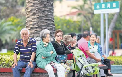  ?? AFP ?? Elderly people rest along the beach in Sanya in this photo taken on February 15, 2017.