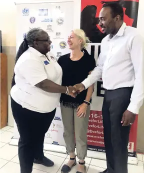  ?? CONTRIBUTE­D ?? Joy Crawford (left), director of impact, EVE For Life, greets Dr Kevin Harvey, Caribbean regional director, AIDS Healthcare Foundation (AHF). Looking on is Margareta Marro, senior director of global accounting and finance, AHF.