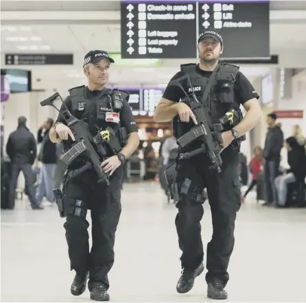  ??  ?? 0 Armed police officers on patrol in the concourses at Edinburgh Airport