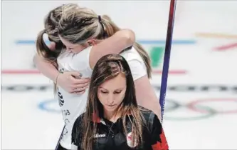  ?? NATACHA PISARENKO THE ASSOCIATED PRESS ?? Canada’s skip Rachel Homan leaves the ice as Britain’s Lauren Gray, right above, and Vicki Adams celebrate their win that ended Canada’s hopes for a medal.