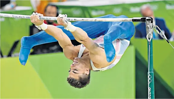  ??  ?? In full flow: Max Whitlock performs on the high bars on his way to winning a bronze medal, Great Britain’s first in the all-around competitio­n for 108 years
